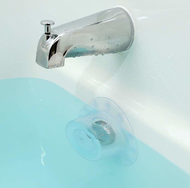 The clear cover placed over the bath's overflow drain, enabling the tub to be filled beyond the overflow drain level.