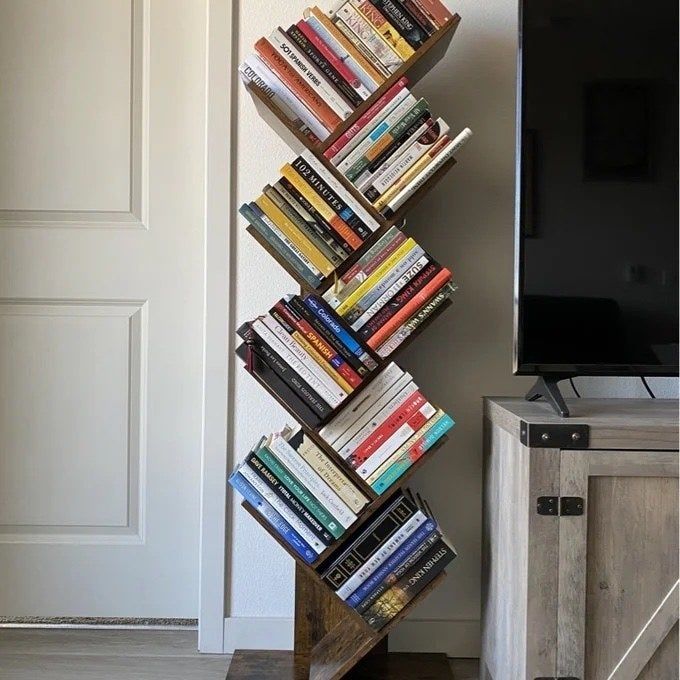 This sleek, geometric bookcase is beautifully adorned with books, adding a modern touch to your space.