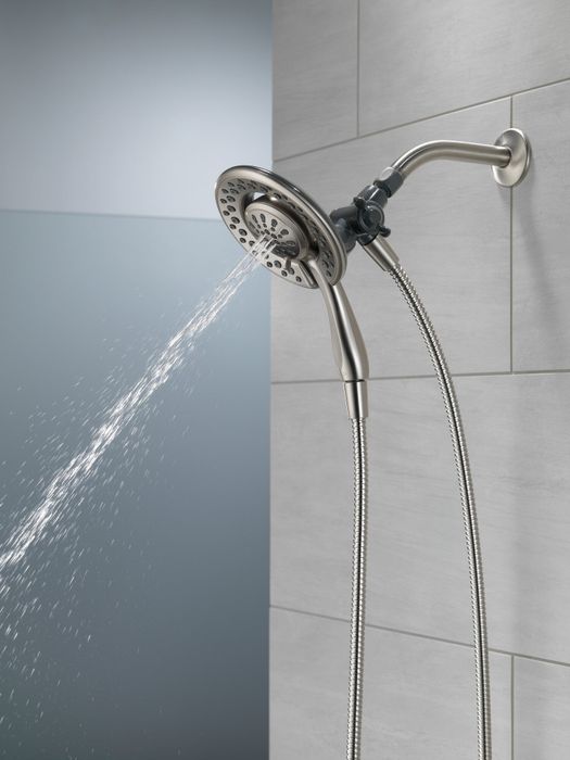 A showerhead with dual nozzles installed in the shower.