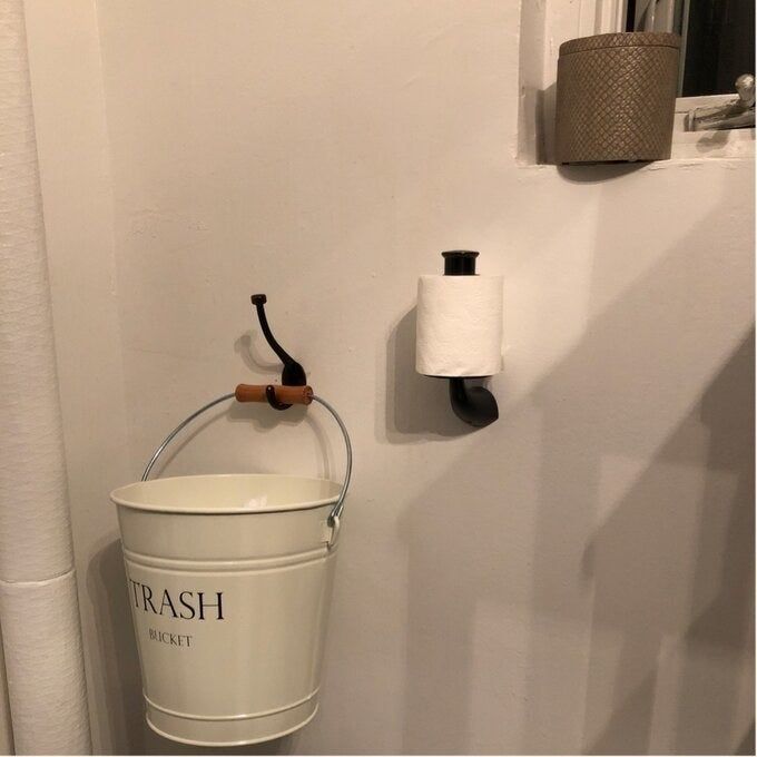 the same wastebasket mounted on a bathroom wall