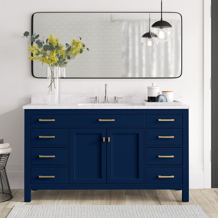 A sleek blue bathroom vanity featuring luxurious gold handles, a perfect addition to elevate the look of any bathroom.