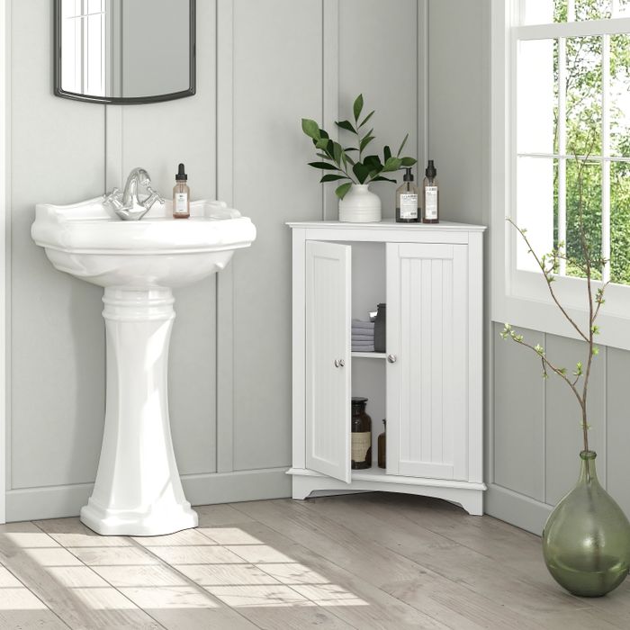 The corner freestanding cabinet swings open to reveal two spacious shelves inside.