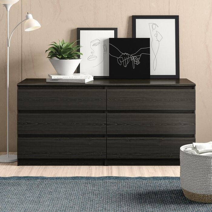 The double dresser with various items arranged on top, placed in a room