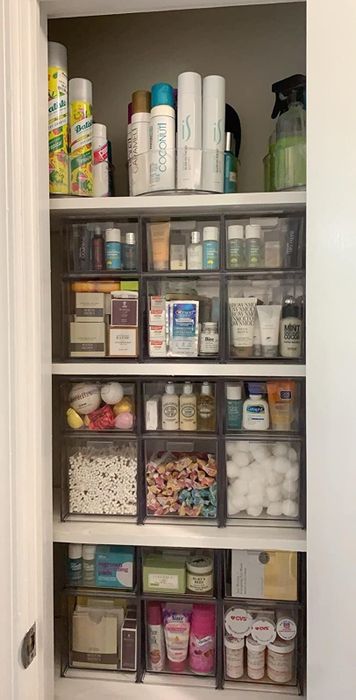 A bathroom cabinet filled with various personal care items and toiletries, all carefully arranged on shelves for easy access and a tidy look.