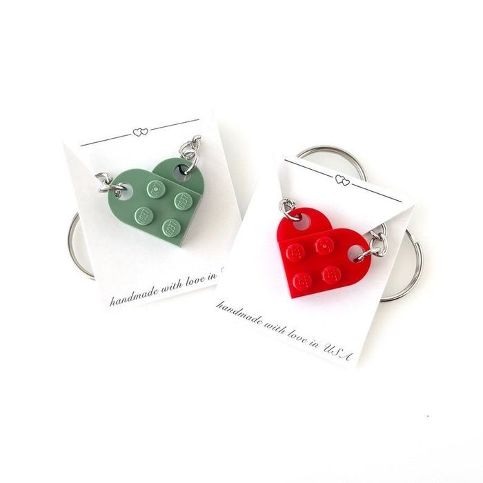 a green Lego heart keychain paired with a red Lego heart keychain
