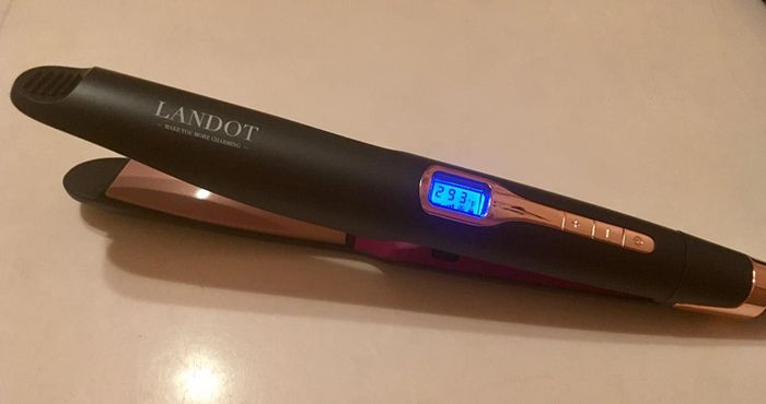 Image of a black and pink hair straightener featuring a digital display, as shared by a reviewer.