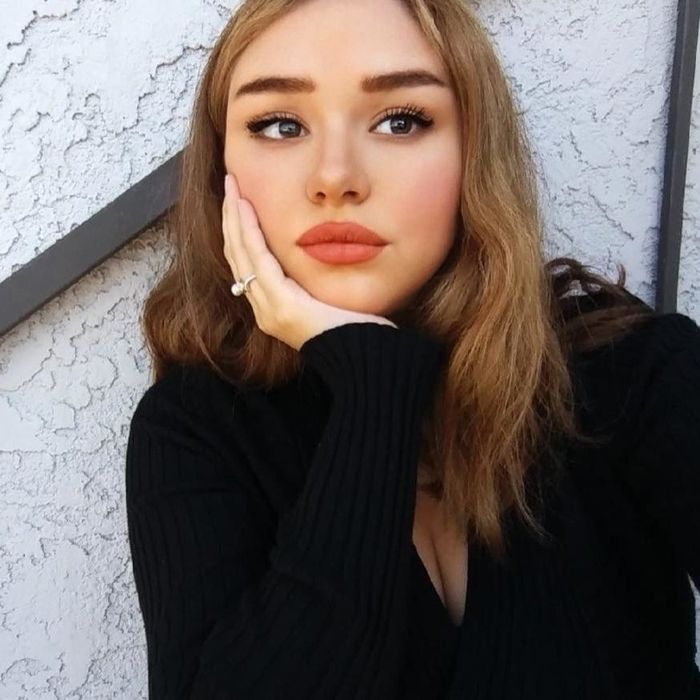 a reviewer with a soft rosy lip tint applied