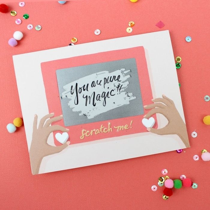 A card designed like an Etch A Sketch toy, revealing a hidden message when scratched