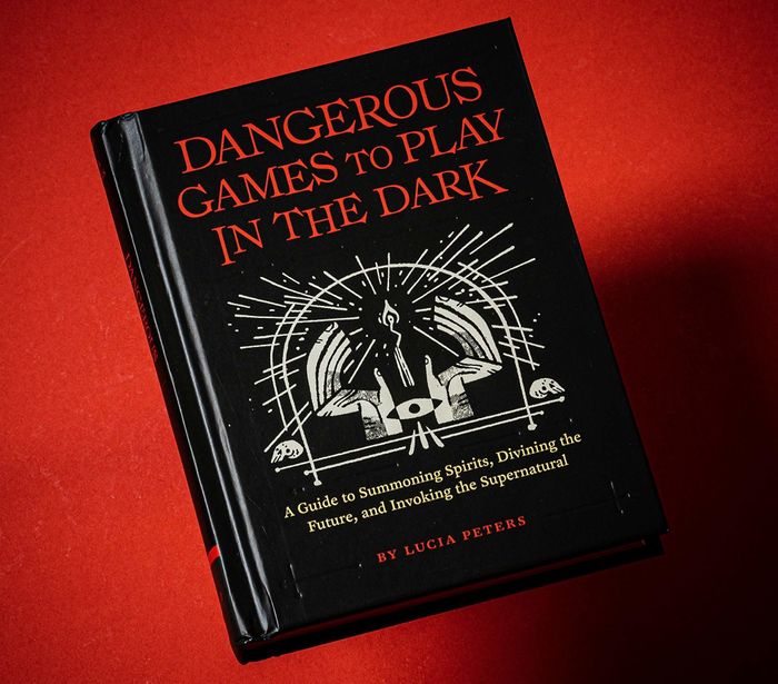 The book set against a red and shadowy backdrop