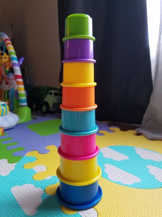 A reviewer's photo showcasing the colorful stacking cups arranged into a fun tower.