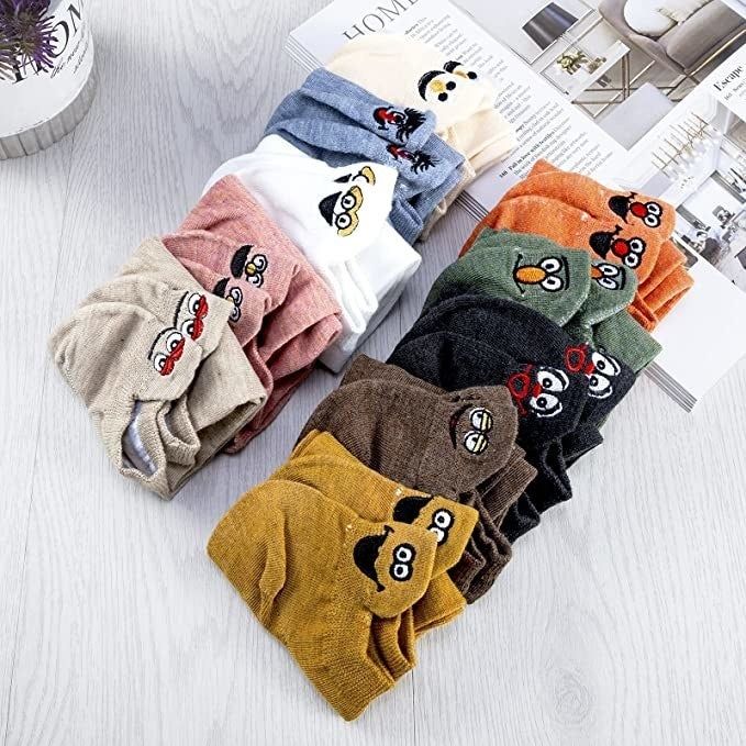 Ten pairs of folded, colorful socks with expressive designs in various hues