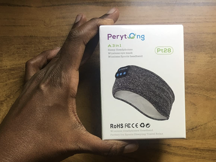 A customer review image showing them holding the packaging of the sleep headband.
