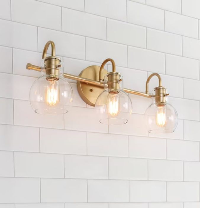 Gold vanity light with three bulbs