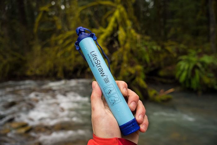 A person holding the LifeStraw water filter.