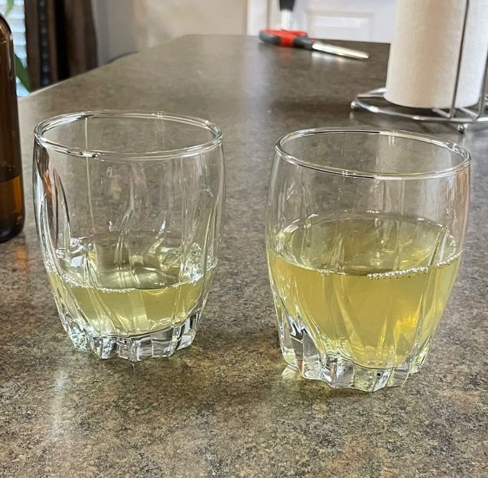 two glasses of mead placed on a countertop