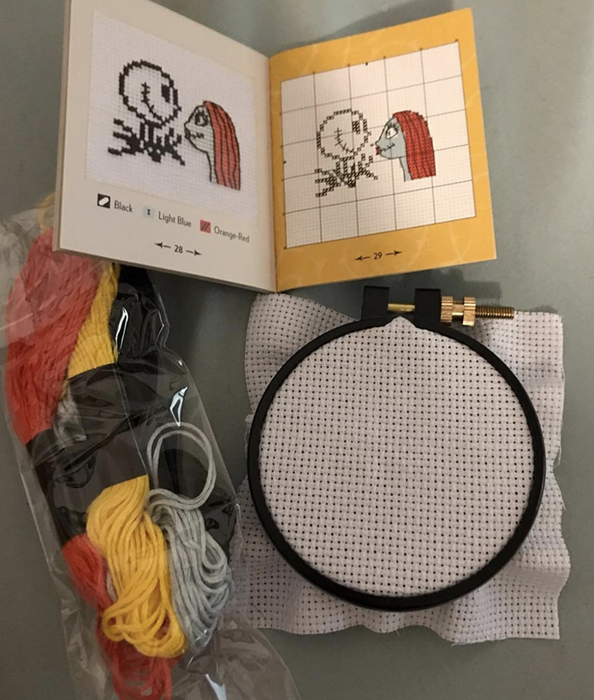 A different reviewer's cross-stitching materials neatly arranged.