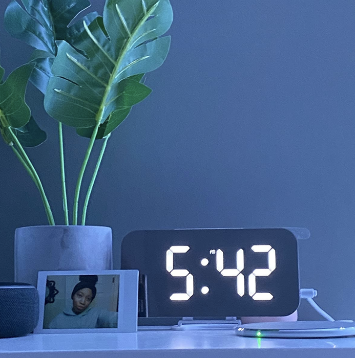 A customer review photo of the clock placed on their nightstand