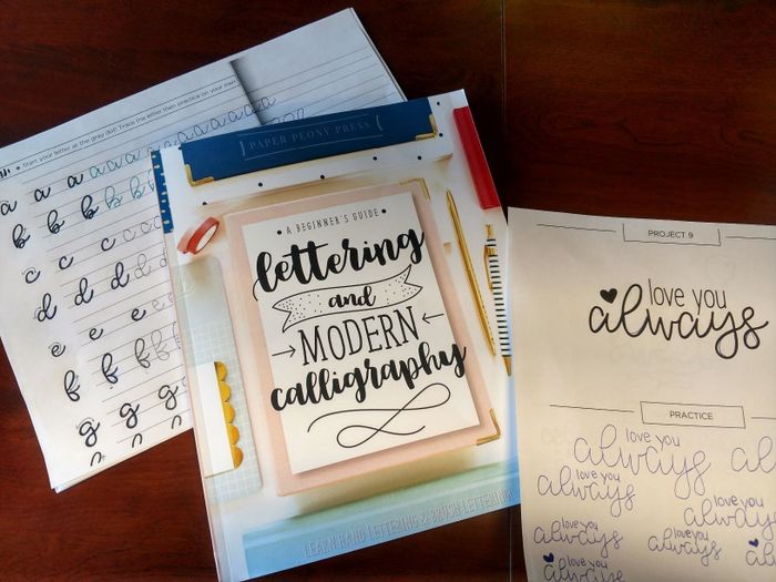 A reviewer photo of the book with practice lettering placed next to it.