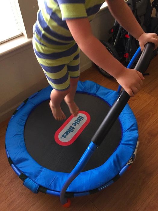 A photo from a reviewer showing their child jumping on the trampoline