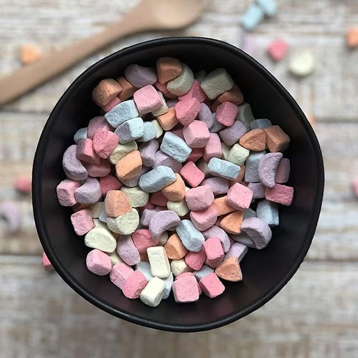 A black bowl filled with vibrant rainbow-colored cereal marshmallows