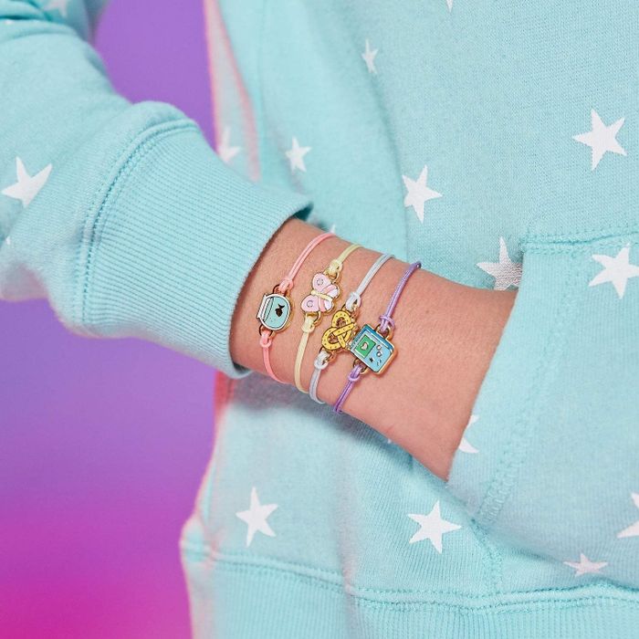 A model showcasing a stack of four bracelets on her wrist.