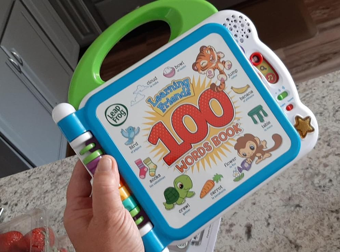 A reviewer is holding the interactive book, showcasing its engaging features.