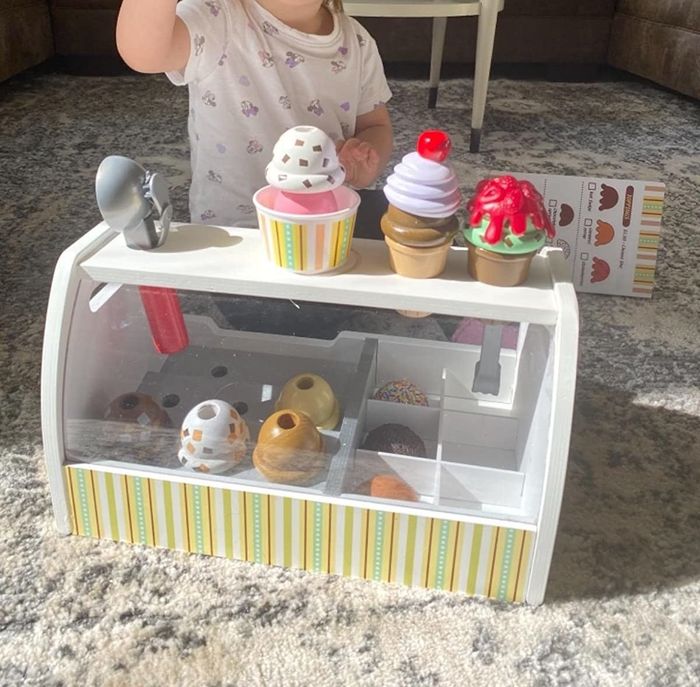 A reviewer's child having fun with the ice cream counter set.