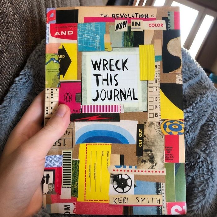 A customer’s review photo of them holding their Wreck This Journal.