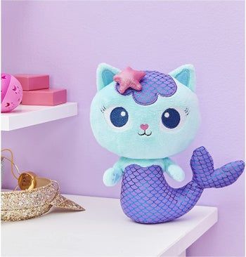 The plush MerCat, a delightful blend of purple and blue, featuring a whimsical cat mermaid design.