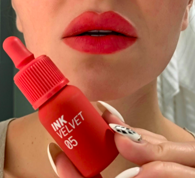 A customer review photo showcasing them wearing the Ink Velvet 05 and holding the bottle.