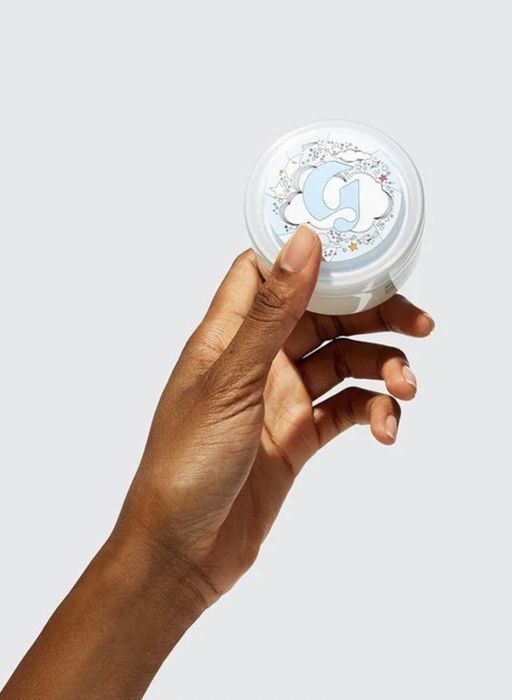 A hand holding the tube of the Moon Mask.