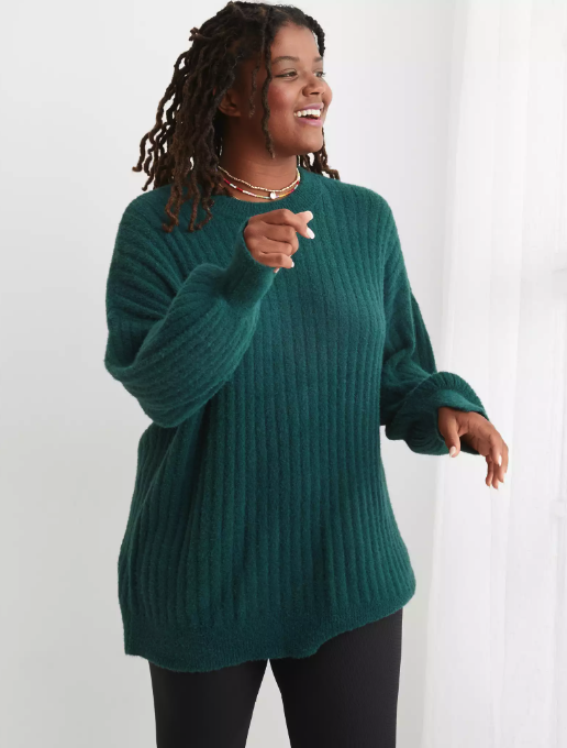 a model dressed in a dark green sweater