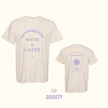 a tan graphic tee featuring lavender text with the message 
