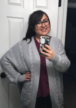 a reviewer wearing the cardigan in a chic grey color