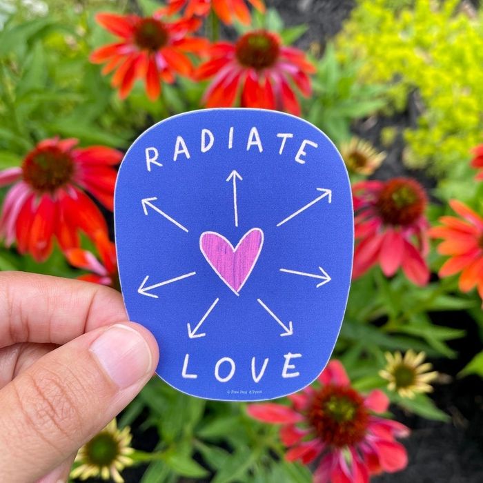 A blue sticker featuring a heart graphic with arrows and the words RADIATE LOVE.