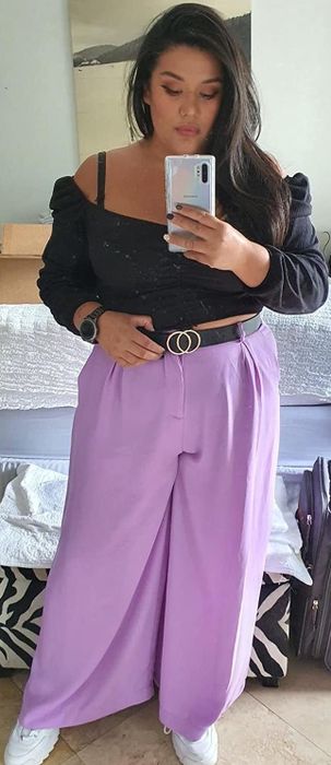 A reviewer rocking the lavender pants