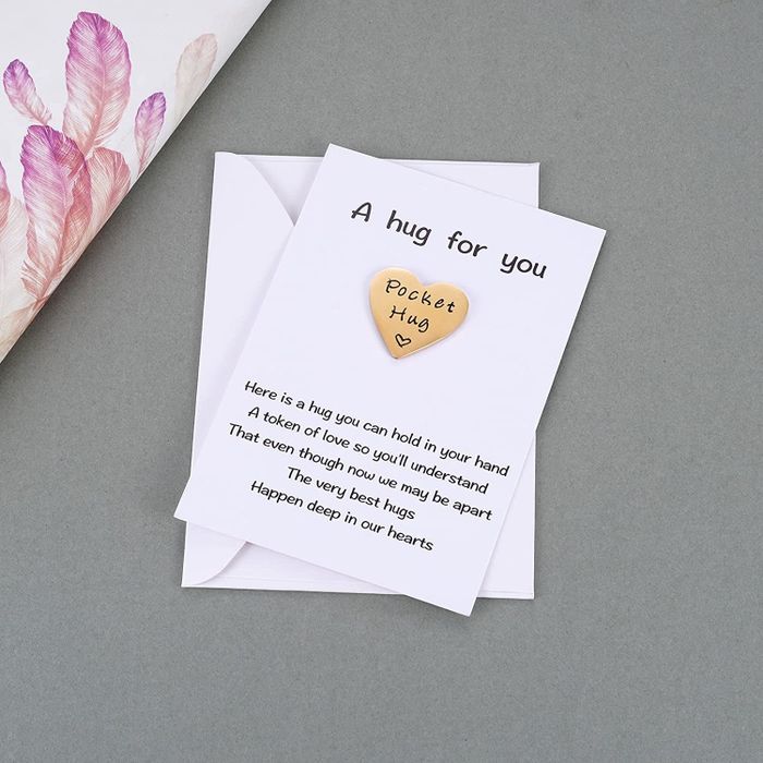 The gold pocket hug token, with a short explanatory note attached on the card.