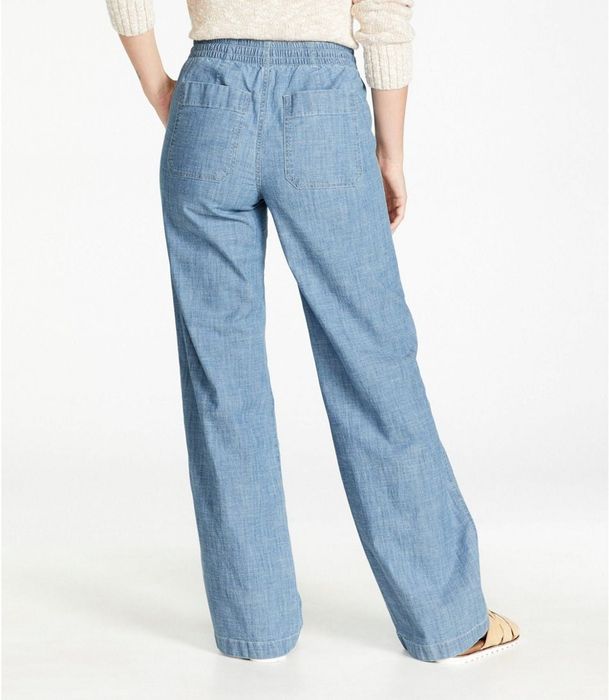A back view of the model wearing the chambray pants, showing off the design.