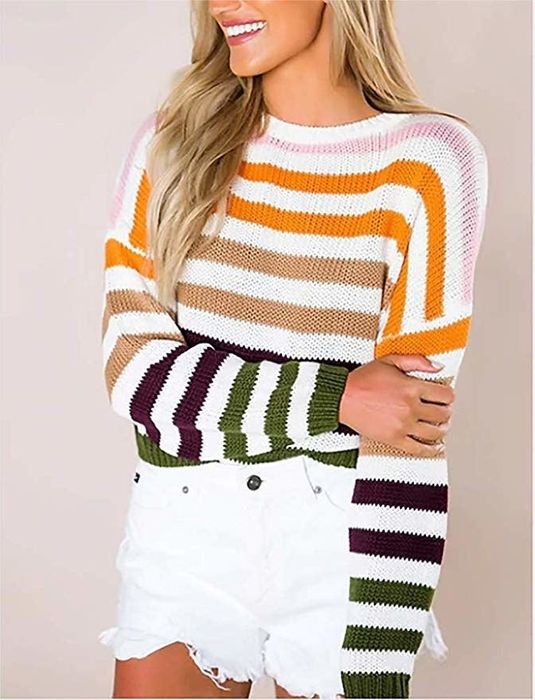 A model wearing the sweater with multicolored stripes