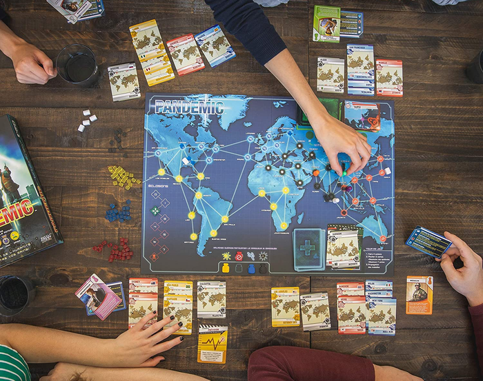 a top-down perspective of the game board with cards laid out around it 