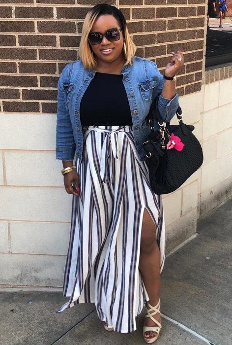 A front-facing view of the reviewer wearing the black and white striped pants.