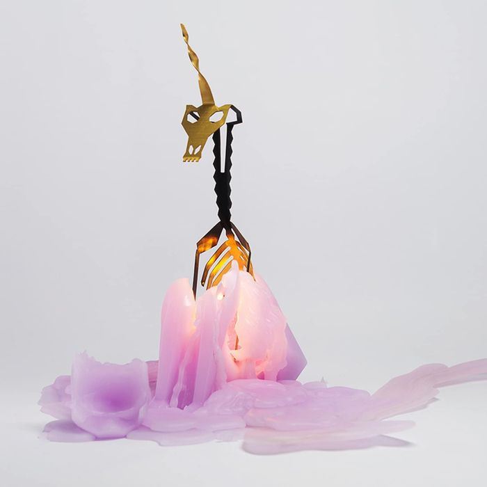 The melted purple unicorn candle revealing its metal skeleton inside.