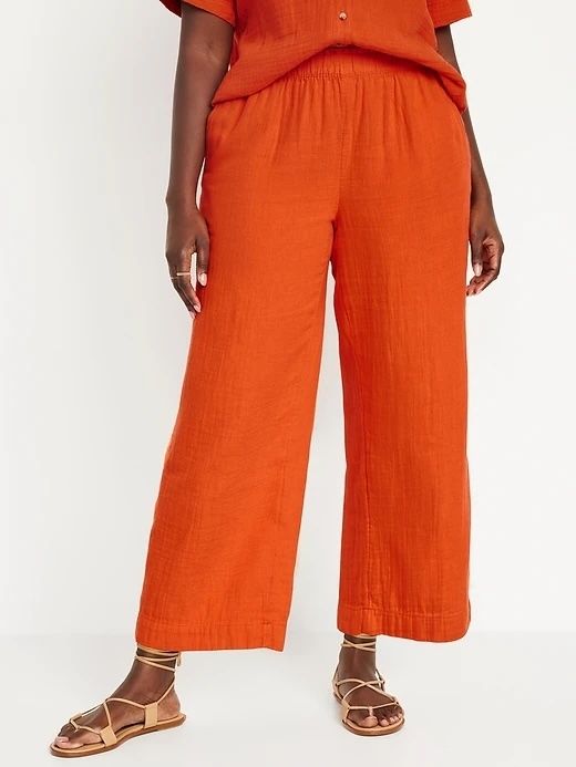 A model wearing cropped wide-leg pants paired with strappy sandals.