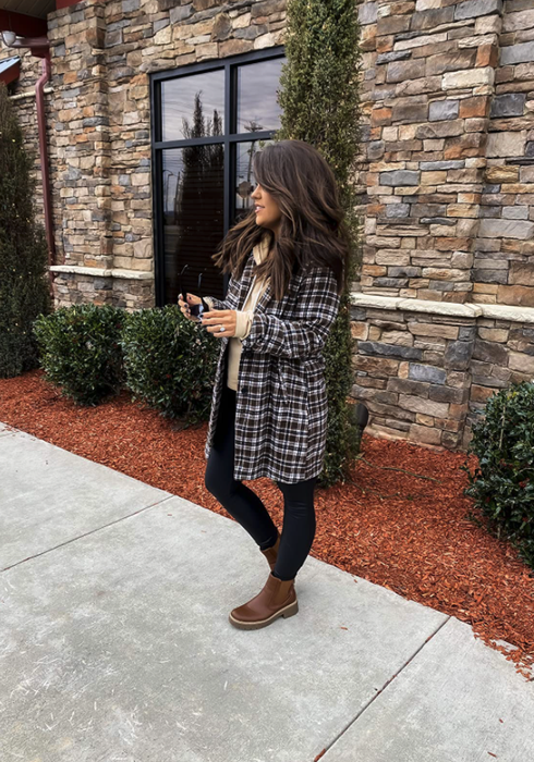 reviewer styled with boots and a hoodie underneath