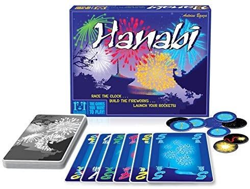 The game includes a board box, playing cards, and circular tokens featuring firework illustrations.