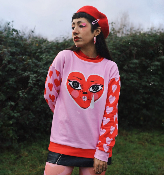 A model is wearing a red and pink shirt