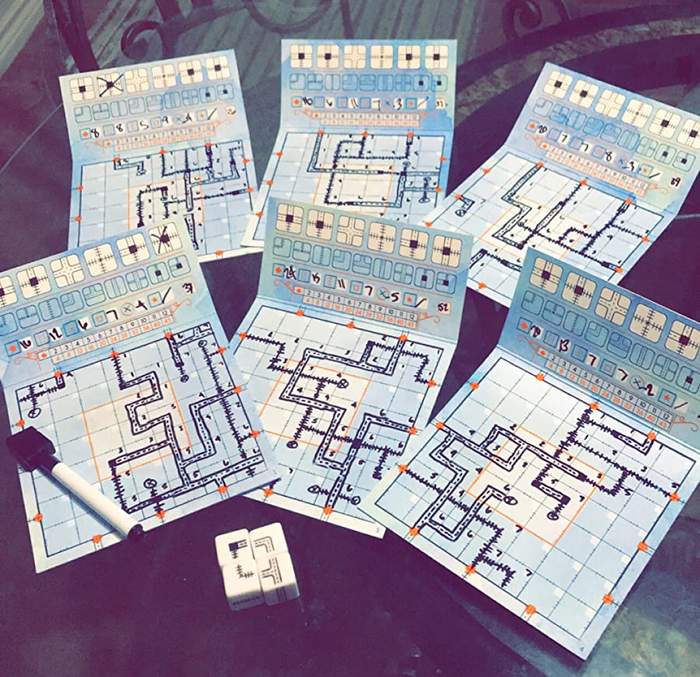 Six dry erase boards featuring different track designs and four dice are included