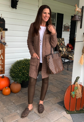 A reviewer showing off the cardigan in a rich brown shade.