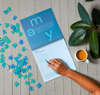 Person filling out the May calendar page