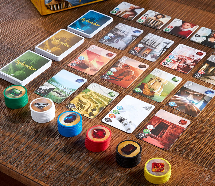 playing cards and gem tiles arranged on a table 